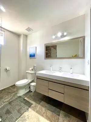 a bathroom with a toilet and a sink and a mirror at Mariposa Reina B in El Jagüey