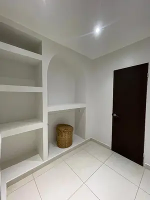 a room with white shelves and a black door at Mariposa Reina B in El Jagüey