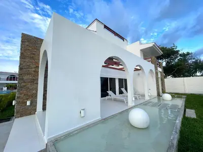 a white villa with a swimming pool at Mariposa Reina B in El Jagüey