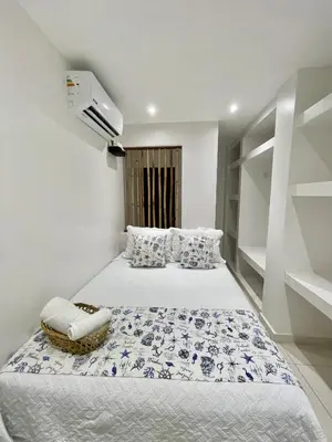 a bedroom with two beds and a air conditioner at Mariposa Reina B in El Jagüey