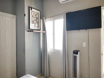 a bedroom with a window and a bed with curtains at Disfruta y siéntete como en casa in San Miguel