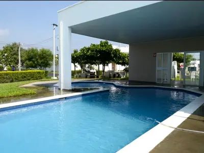 a large blue swimming pool in a building at Disfruta y siéntete como en casa in San Miguel