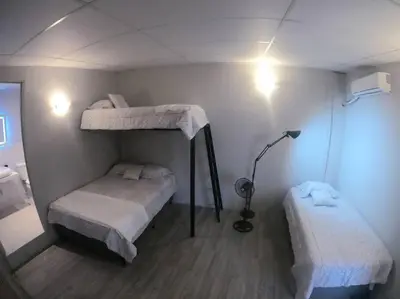 a room with two bunk beds and a lamp at Apto para turismo. Moderno cómodo y panorámico. in San Salvador