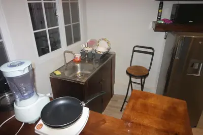 a kitchen with a counter with a sink and a blender at Apto para turismo. Moderno cómodo y panorámico. in San Salvador