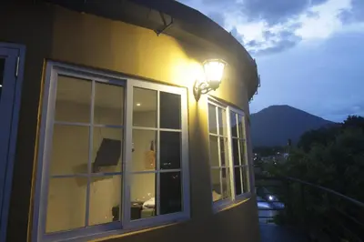 a house with a light on the side of it at Apto para turismo. Moderno cómodo y panorámico. in San Salvador