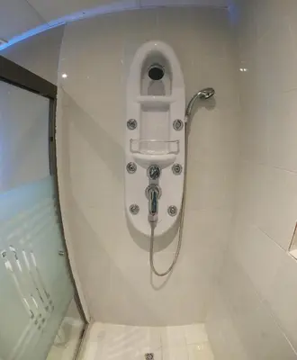 a shower with a hose in a bathroom with a toilet at Apto para turismo. Moderno cómodo y panorámico. in San Salvador