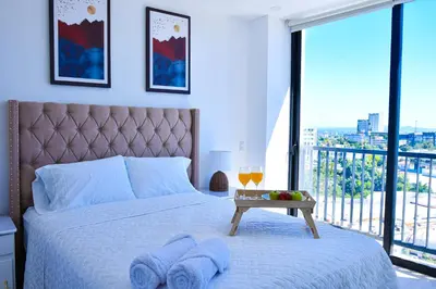 a bedroom with a bed with two towels on it at Modern Apartment in Downtown. A/C+ Wifi! in San Salvador