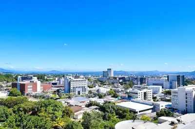 a cityscape of a city with buildings and trees at Modern Apartment in Downtown. A/C+ Wifi! in San Salvador