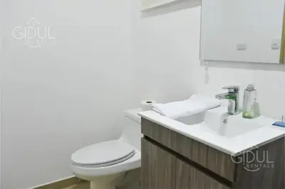 a bathroom with a toilet and a sink at The Downtown Apartment - 3 A/C bedroom + WiFi in San Salvador