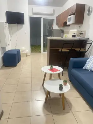 a living room with a blue couch and a table at Tiny house Santa Ana in Santa Ana