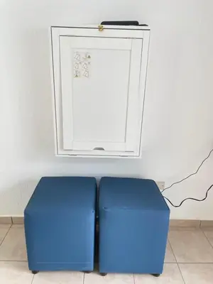 two blue ottomans sitting next to each other in a room at Tiny house Santa Ana in Santa Ana