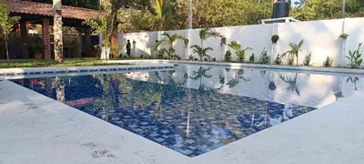 a swimming pool in a house with a tile floor at Cielo Azul in La Libertad