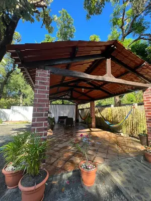 a wooden pergola with potted plants on a patio at Cielo Azul in La Libertad