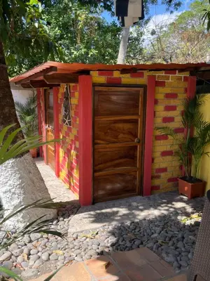 a garage with a wooden door in front of it at Cielo Azul in La Libertad