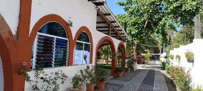 a building with arched windows and potted plants on it at Cielo Azul in La Libertad