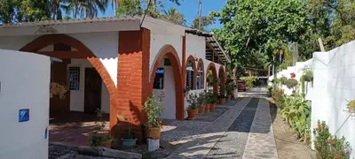 an alley with a building with arches and potted plants at Cielo Azul in La Libertad