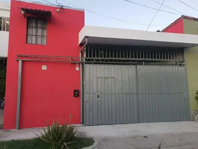 a red building with a red garage door at Buena Vista Home in Nueva San Salvador