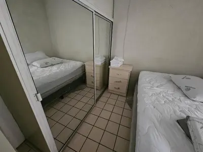 a small room with two beds and a mirror at Buena Vista Home in Nueva San Salvador