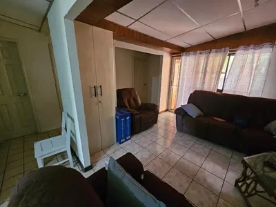 a living room with a couch and a chair at Buena Vista Home in Nueva San Salvador