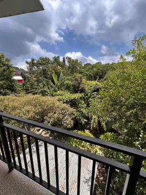 a balcony with a view of trees and bushes at Country House in Los Planes VACATION RENTAL in Panchimalco