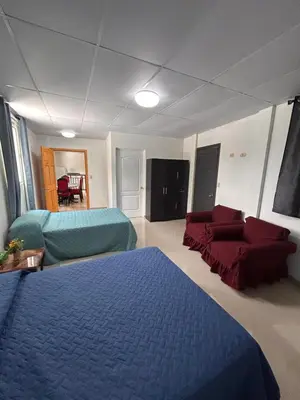 a living room with a blue bed and a couch at Country House in Los Planes VACATION RENTAL in Panchimalco