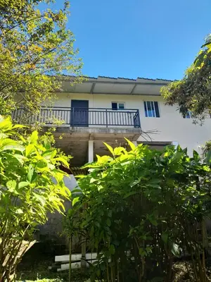 a building with a balcony and trees in front of it at Country House in Los Planes VACATION RENTAL in Panchimalco