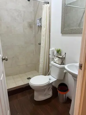 a bathroom with a shower and a toilet and a sink at Barú in La Libertad