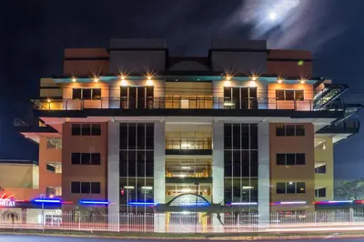 a building with lights on top of it at night at Hotel Tropico Inn in San Miguel