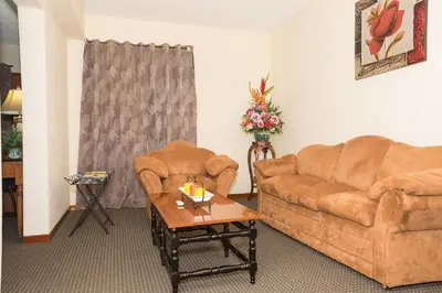 a living room with a couch and a coffee table at Hotel Tropico Inn in San Miguel