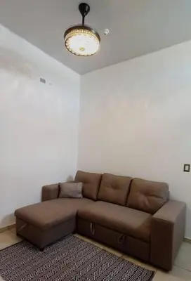 a brown couch in a living room with a light at Modern Townhouse AC Wi-Fi full equipped Private in Santa Ana