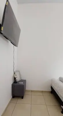 a white room with a bed and a flat screen tv at Modern Townhouse AC Wi-Fi full equipped Private in Santa Ana