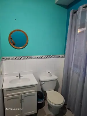 a bathroom with a toilet and a sink and a mirror at Casaca in Concepción de Ataco