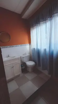 a bathroom with a toilet and a sink at Casaca in Concepción de Ataco