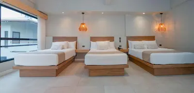 a bedroom with two beds and a large window at Mirasurf Hotel & Waves in El Sunzal