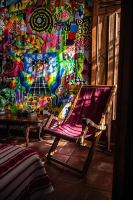 a chair in a room with a colorful wall at Hotel Anáhuac in Juayúa