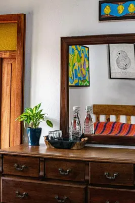 a dresser with a mirror and two bottles on it at Hotel Anáhuac in Juayúa