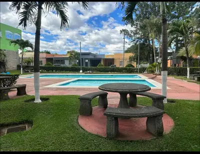a picnic table in front of a swimming pool at Apartamento entero Rebeca house in Santa Ana