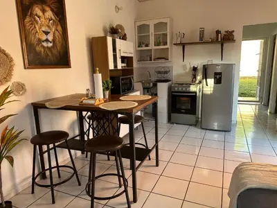 a kitchen with a table and chairs and a refrigerator at Apartamento entero Rebeca house in Santa Ana