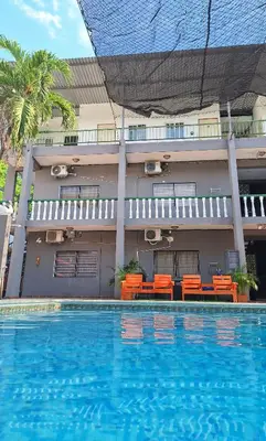 a hotel with a swimming pool in front of a building at Coastal Paradise Estudio Cerca de Sunset Park y Playa in La Libertad