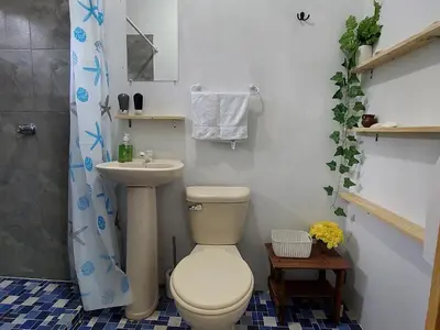 a bathroom with a toilet and a sink at Coastal Paradise Estudio Cerca de Sunset Park y Playa in La Libertad