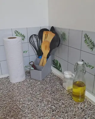 a kitchen counter with a container of cooking utensils at Coastal Paradise Estudio Cerca de Sunset Park y Playa in La Libertad