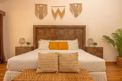 a bedroom with a large bed with two night stands at The rooftop Beach & club in La Libertad