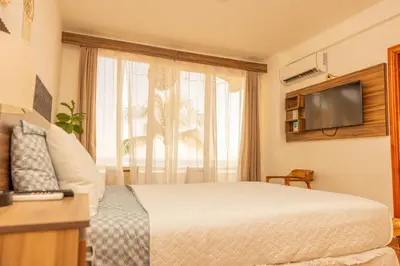 a hotel room with a bed and a television at The rooftop Beach & club in La Libertad