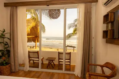 a room with a window with a view of the beach at The rooftop Beach & club in La Libertad