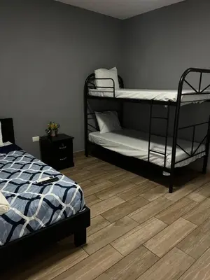 a bedroom with two bunk beds and a wooden floor at Rancho Agua Fria in Jucuarán