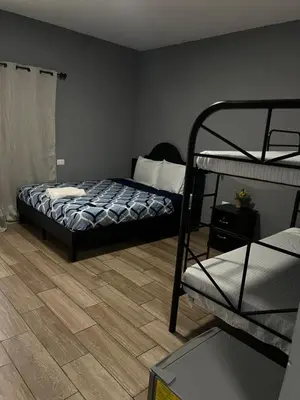a bedroom with a bed and a bunk bed at Rancho Agua Fria in Jucuarán