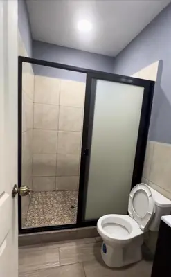 a bathroom with a shower with a toilet in it at Rancho Agua Fria in Jucuarán