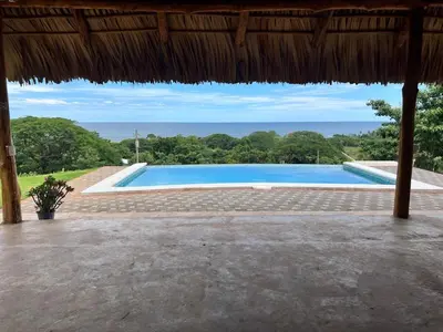 a swimming pool with a view of the ocean at Rancho Agua Fria in Jucuarán