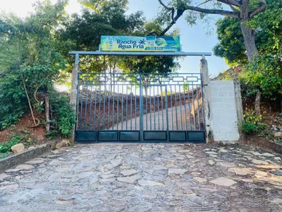 a gate with a sign on top of it at Rancho Agua Fria in Jucuarán