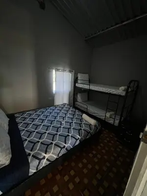 a bedroom with two bunk beds and a window at Rancho Agua Fria casa in Usulután